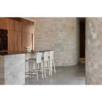 GlobeWest Rufus Indra Goblet Bowl in green onyx marble displayed on a kitchen counter with modern white stools.