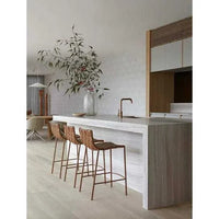 Three GlobeWest Everly Barstools in linen grey with matte grey powder-coated legs at a modern kitchen island
