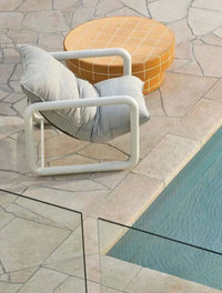 GlobeWest Seville Tile round honey coffee table with white grid pattern by poolside