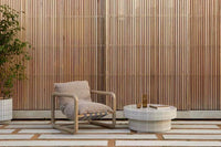 GlobeWest Seville Tile round honey coffee table with tiled surface and modern outdoor chair on patio