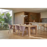 GlobeWest Frankie Dining Table in natural ash veneer with chunky legs in a modern dining room setting