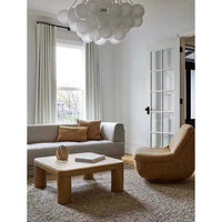 GlobeWest Tobi Occasional Chair in hay color with rounded silhouette and plush cushioning in a modern living room setting