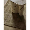 GlobeWest Tepih Neptune Rug in olive hand-woven wool blend with subtle rustic texture under marble table
