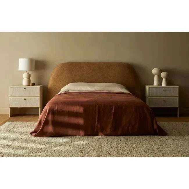 Modern GlobeWest Emery Bodhi Table Lamp in dune sand with ceramic base and linen shade on bedside table in bedroom setting