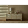 GlobeWest Lorne Post Table Lamp with light grey ceramic base and ivory fabric shade on wooden sideboard in neutral room