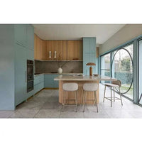 Easton Ellipse Table Lamp in olive green metal shade with travertine marble base on kitchen island