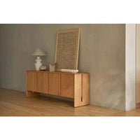 GlobeWest Lorne Bronte Table Lamp with ceramic rustic white base and oatmeal fabric shade on wooden sideboard in minimalistic room