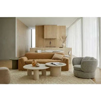 Pippa Coffee Table in chai finish with piped edge, ash veneer top, and sculptural pedestal base in modern living room setting