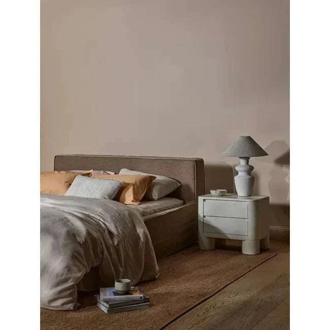 GlobeWest Lorne Bronte ceramic table lamp with oatmeal linen shade on bedside table in modern bedroom setting