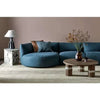 Dark teal Slipper modular sofa with curved design and crescent forms in modern living room setting