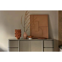 Glazed flaxen porcelain Forme Hyacinth Vase with sculptural shape on a console with branches and warm decor