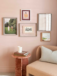 modern acrylic box gallery frame in sage showcasing various artworks on pink wall