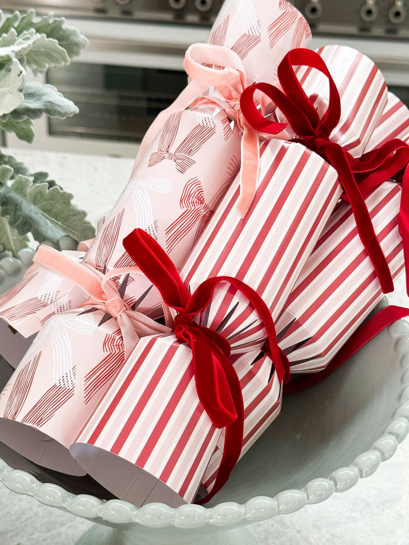 Set of 6 norsu Studio Christmas crackers with elegant velvet ribbons in festive pink and red designs