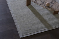 GlobeWest Bower Frame Seaside Blue rug styled on a dark timber floor