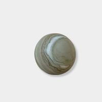 CoTheory Orbit Table Sculpture green marble sphere symbolizing harmony and balance