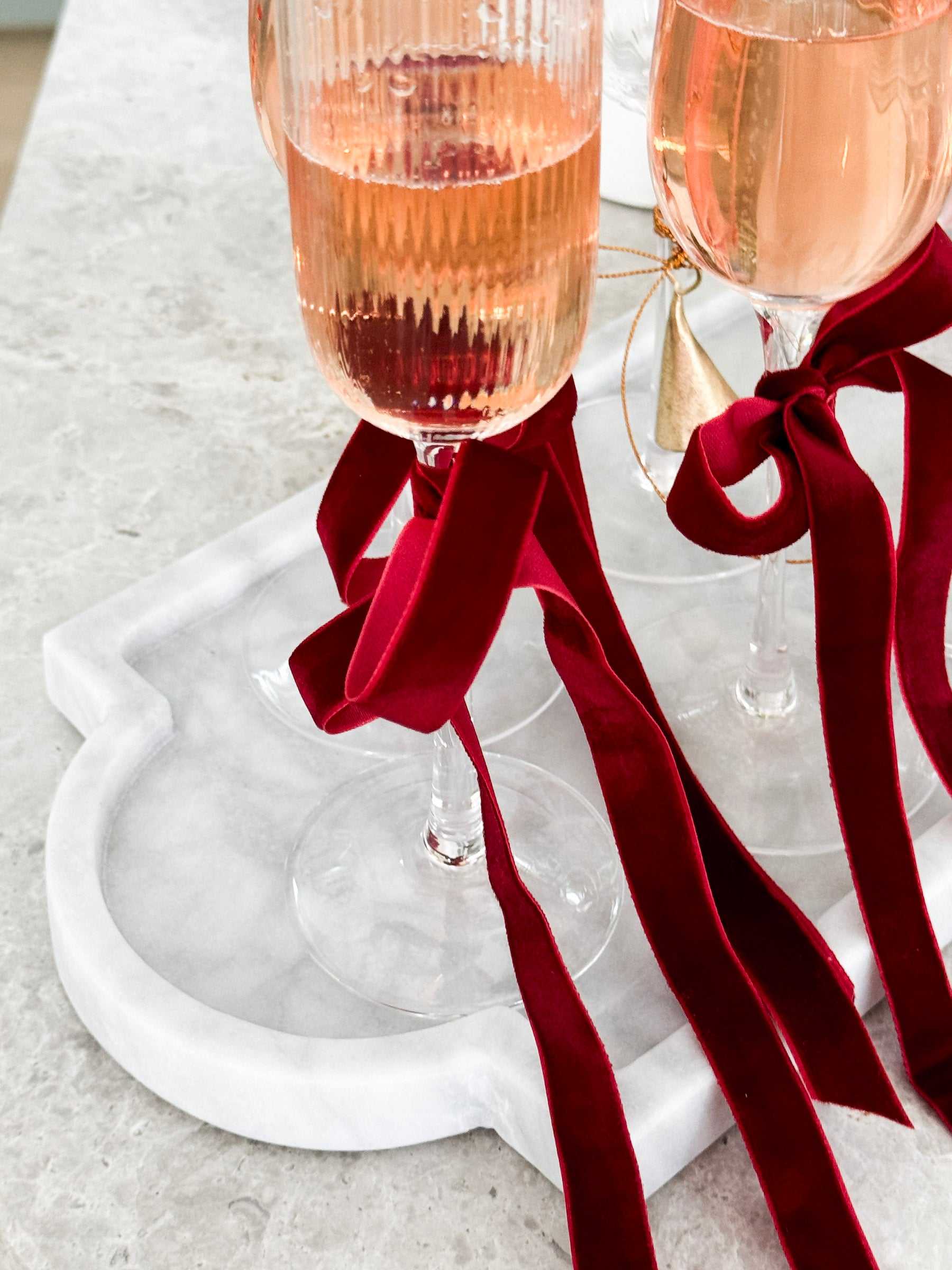 norsu STUDIO Marble Long Tray Calacatta white marble serving board with red ribbon-wrapped glasses