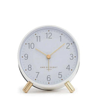 Maisie Silent Tick Alarm Clock in white with gold legs, hands, and numerals, featuring a vintage-inspired rounded design and silent tick function
