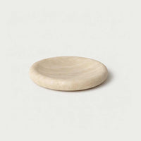 Small beige sculpted travertine tray with smooth curved design for decorative and functional use