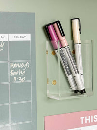 Sky blue magnet meal planner on fridge with markers for weekly menu organization