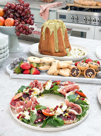 norsu STUDIO Marble Long Tray with assorted charcuterie and desserts on kitchen counter