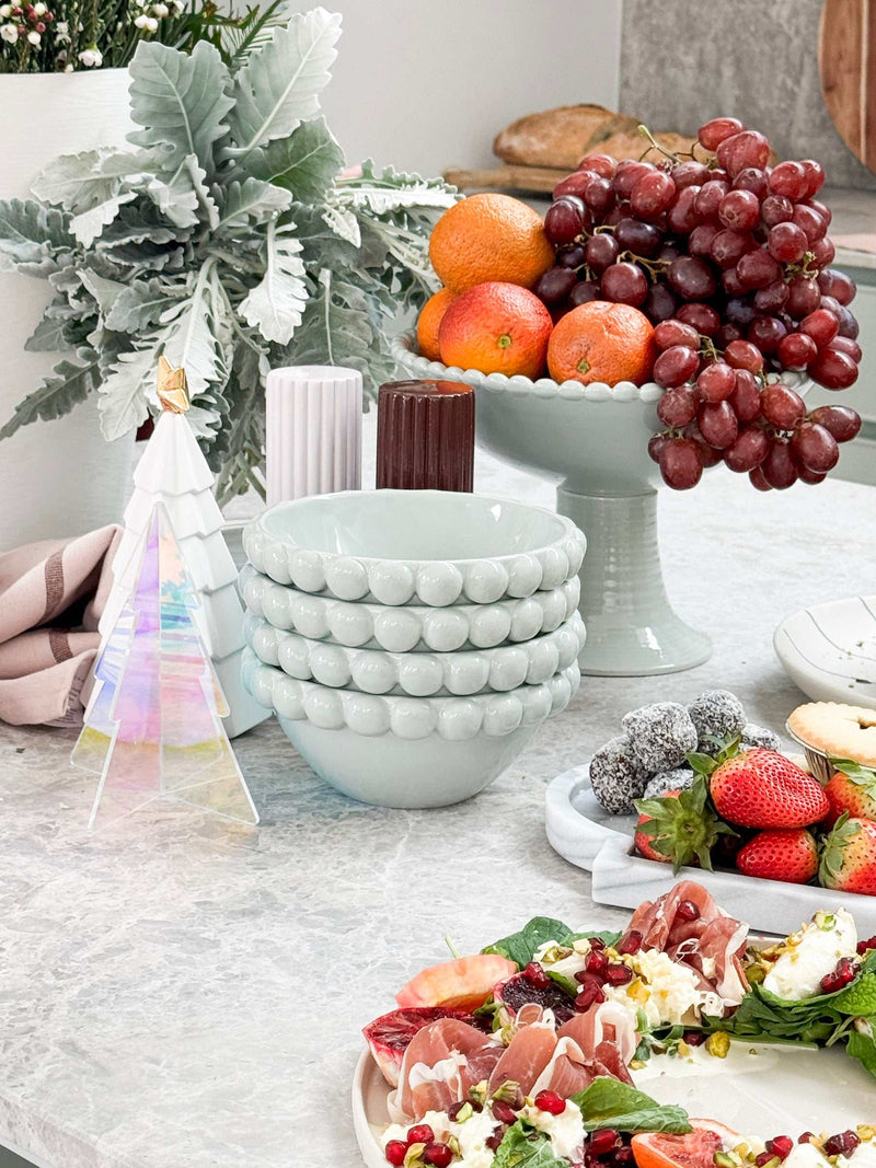 Blue Eden Pedestal Bowl ceramic with beaded rim on table with fruit and decor