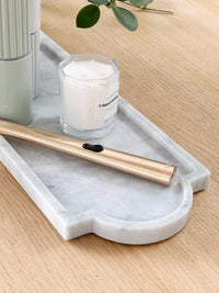 norsu STUDIO Marble Long Tray in white Calacatta marble with grey veining on wooden surface with candle and gold lighter