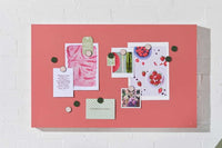Berry colored magnetic story board with notes and photos attached using round magnets on a white wall