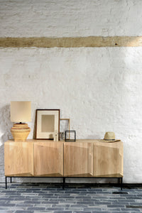 Ethnicraft Oak Stairs Sideboard - 4 Doors, styled in a room setting