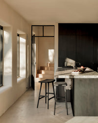 Ethnicraft Osso stool - Black Oak/ Black Leather, styled in a room setting