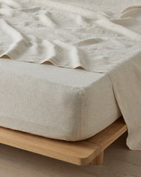 Weave Home Sova fitted sheet in Savanna pinstripe linen on a timber bed base