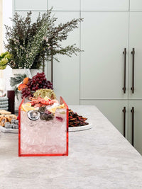 norsu Studio ochre perspex scalloped drink bucket with ice and snacks on kitchen counter