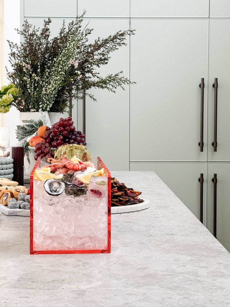 norsu Studio ochre perspex scalloped drink bucket with ice and snacks on kitchen counter