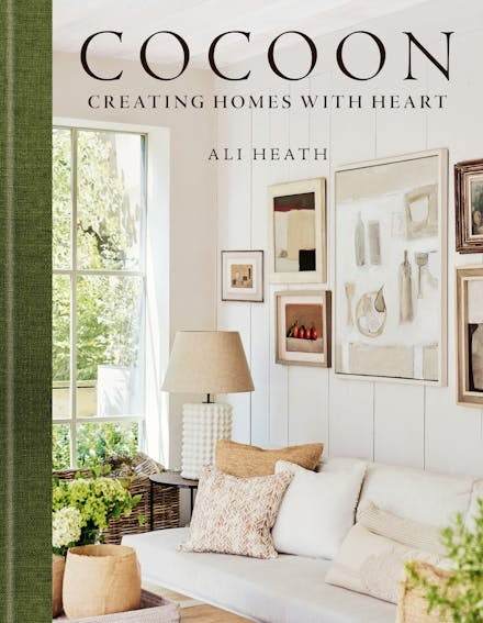 Cocoon by Ali Heath book cover featuring cozy, stylish interior with sofa, cushions, lamp, and framed artwork