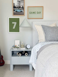 norsu Studio Scalloped Magnetic Photo Frame with blue background on bedside table in modern bedroom setting