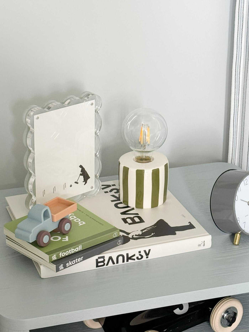 norsu Studio scalloped magnetic photo frame with blue background on shelf with decor items