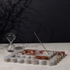 CoTheory Marble Tray Small Scalloped Brown Calacatta Incense Holder with burning incense stick and hourglass on white surface