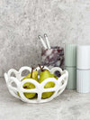 White Rye Stoneware Ceramic Basket with woven design holding green pears on kitchen counter