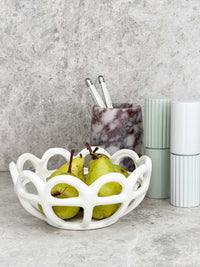 White Rye Stoneware Ceramic Basket with woven design holding green pears on kitchen counter