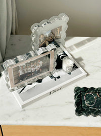 norsu Studio scalloped acrylic magnetic photo frames with sage background on marble surface displaying photos and decorative items