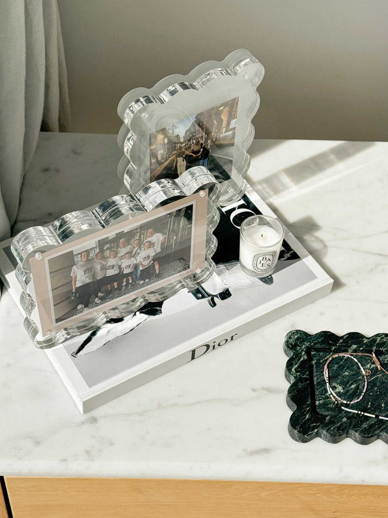 norsu Studio scalloped acrylic magnetic photo frames with sage background on marble surface displaying photos and decorative items