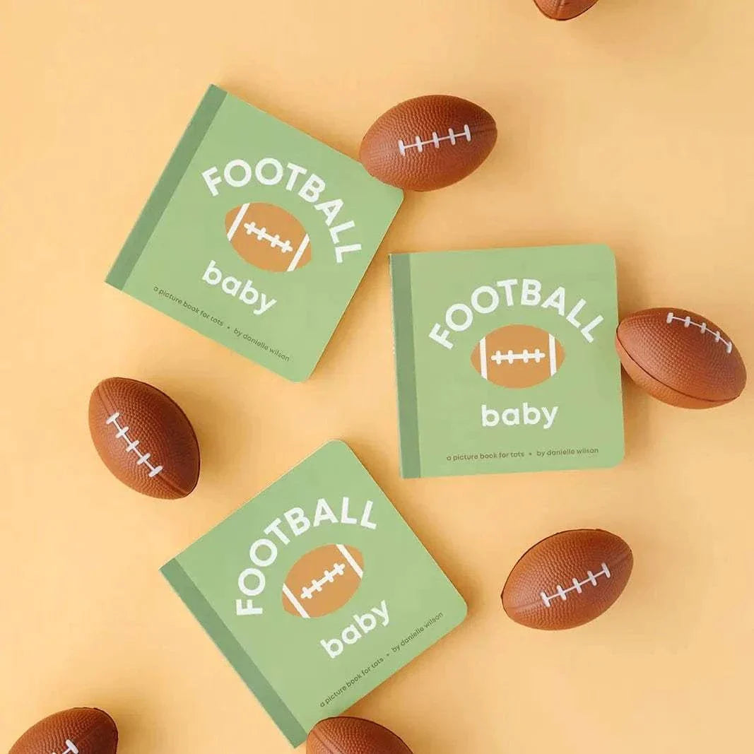 Football Baby board book for toddlers with green cover and football illustration surrounded by small football toys on a beige background