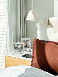 norsu Studio Scalloped Magnetic Photo Frame in sage background on bedside table with cozy cushions and soft natural light