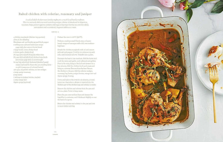 Baked chicken with celeriac, rosemary, and juniper in a white roasting pan from The Beauty Chef cookbook by Carla Oates.