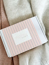 norsu Studio Scalloped Magnetic Photo Frame packaging with pink stripes on soft fabric background