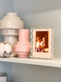 norsu Studio scalloped magnetic photo frame with acrylic background displaying vintage family photo on shelf next to decorative vases