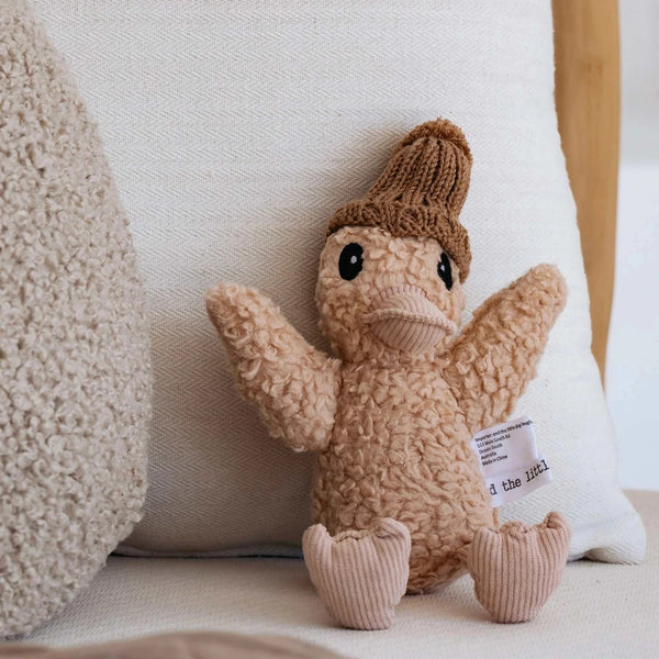 Poppy Duck plush toy wearing caramel merino wool beanie with pink corduroy accents