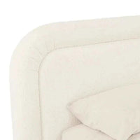 Close-up of the GlobeWest Almos Chubby Bed in king size, featuring ivory boucle fabric and thick tubular upholstered headboard and frame.