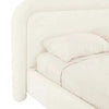 Ivory boucle upholstered GlobeWest Almos Chubby Bed king size with rounded sculptural curves and plush headboard