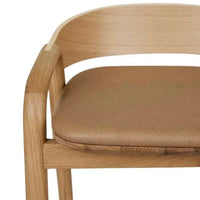Close-up of GlobeWest Tolv Inlay Barstool seat with pecan leather and light oak frame