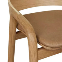 Close-up of GlobeWest Tolv Inlay Barstool with pecan leather seat and light oak frame